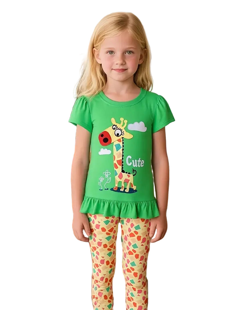 Young girl wearing a green shirt with a giraffe design and colorful pants on a white background