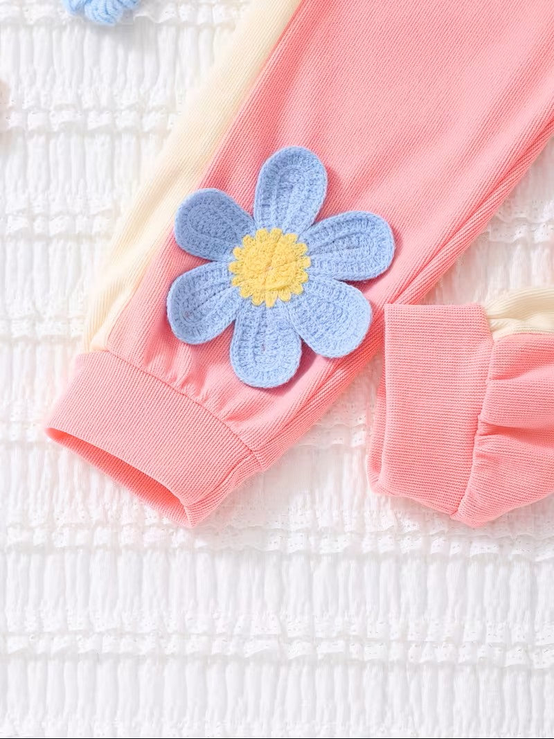 Pink headband with a blue flower accessory on a white background