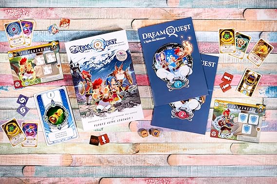 Collection of 'Dream Quest' game cards and booklets on a wooden surface