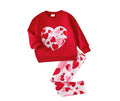 Red sweatshirt with heart pattern and matching pants on a white background