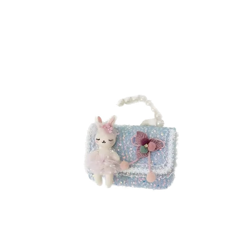 Plush toy llama with a blue glittery bag on a white background