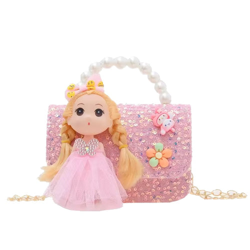 Pink handbag with a doll wearing a pink dress on a white background
