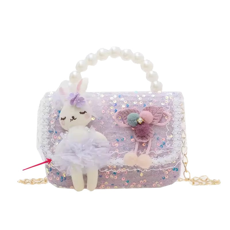 Children's handbag with plush toy and decorative elements on a white background