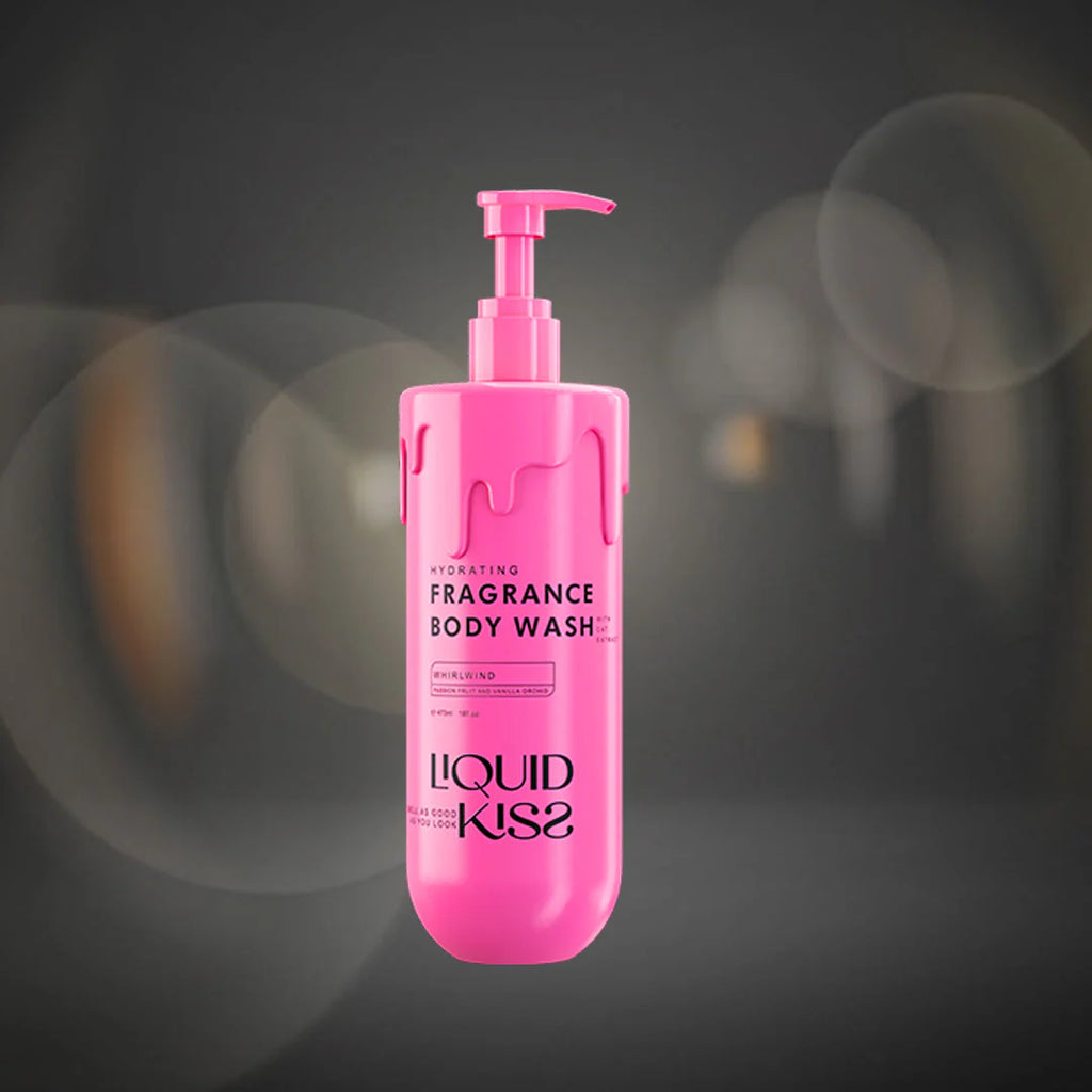 Pink bottle of Liquid Kiss body wash on a dark background