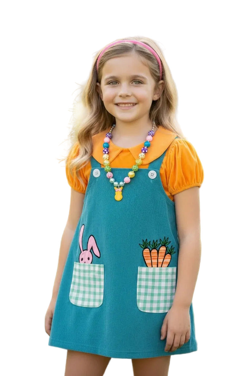 Young girl wearing a colorful dress with bunny and carrot design 