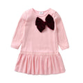 Pink dress with a large brown bow on a white background