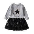Children's outfit with gray sweater and black tulle skirt featuring star patterns on a white background.