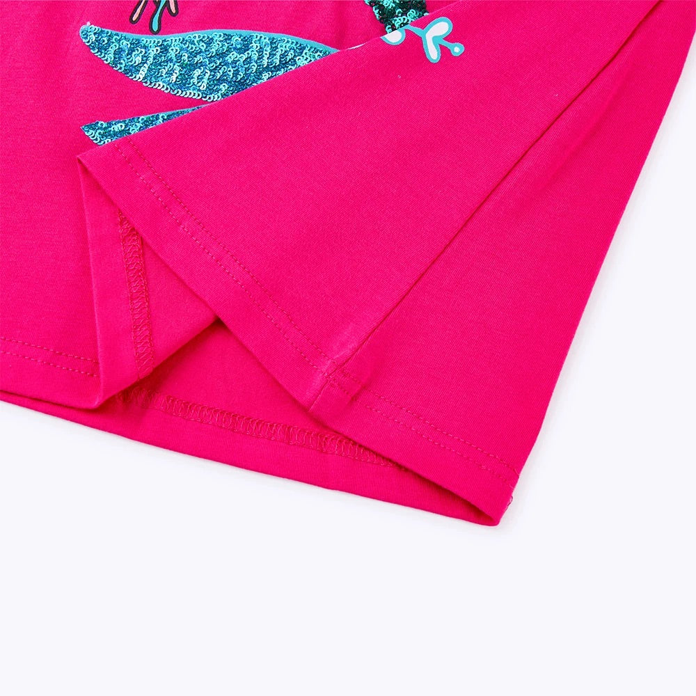 Pink fabric with a dragonfly design on a white background