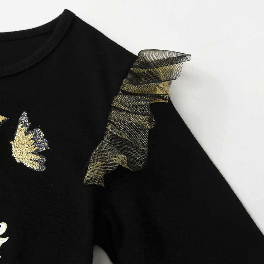 Black long-sleeve top with gold and silver decorative elements on a white background