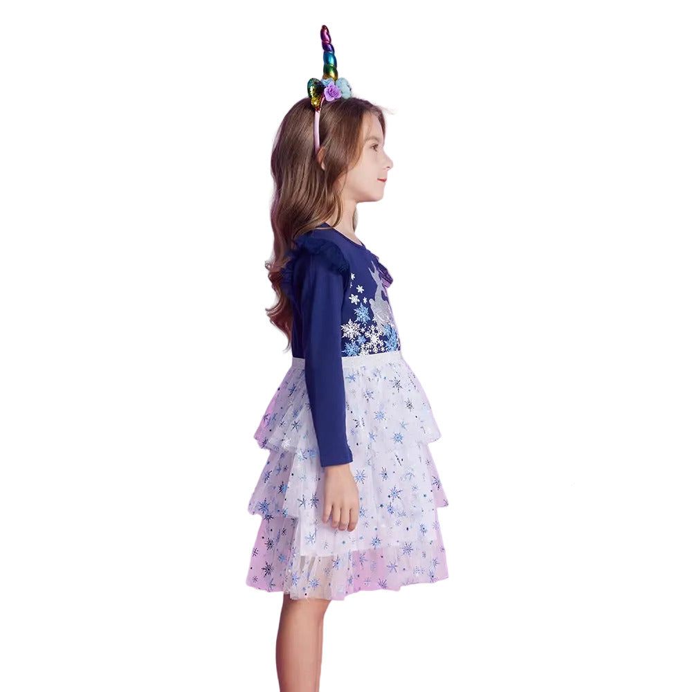 Young girl in a dress with a unicorn horn and balloons on a pink background