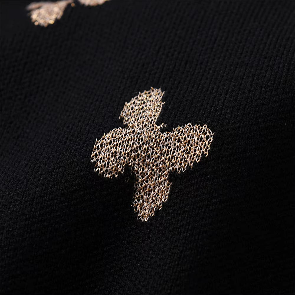 Close-up of a textured cross design on black fabric