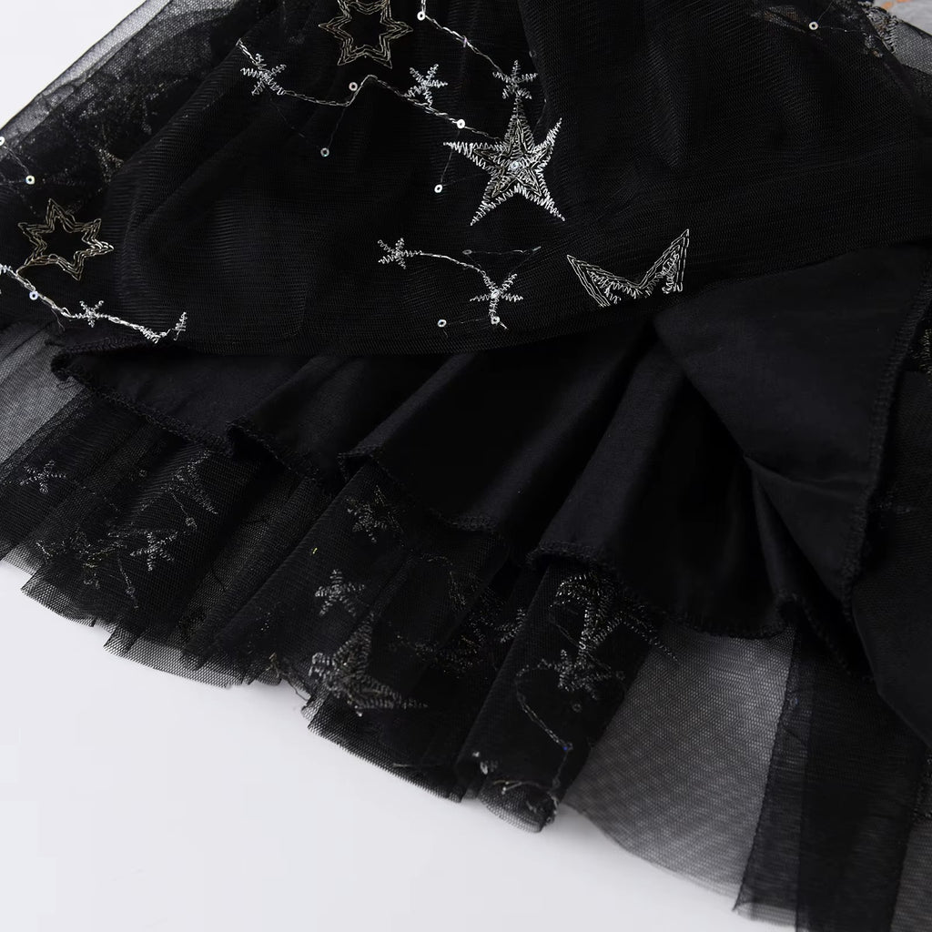 Black tulle skirt with star-shaped embellishments on a white background