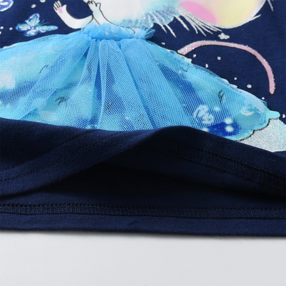 Close-up of a blue tutu skirt on a navy blue fabric with celestial designs.