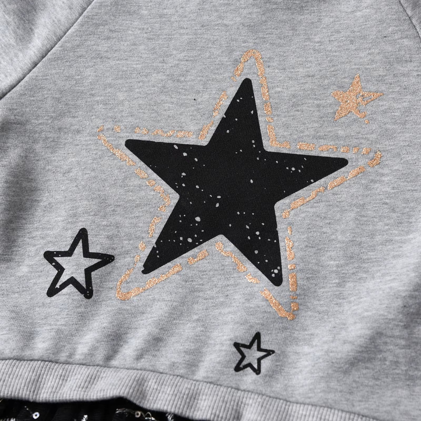 Gray sweatshirt with black star design on a gray background