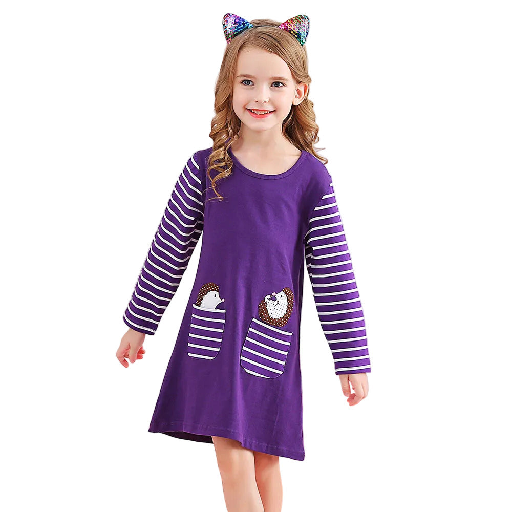 Young girl wearing a purple dress with white stripes and cat ears on a white background