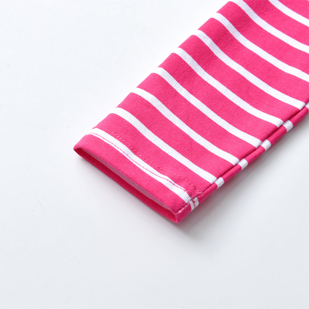 Pink and white striped fabric on a light gray background