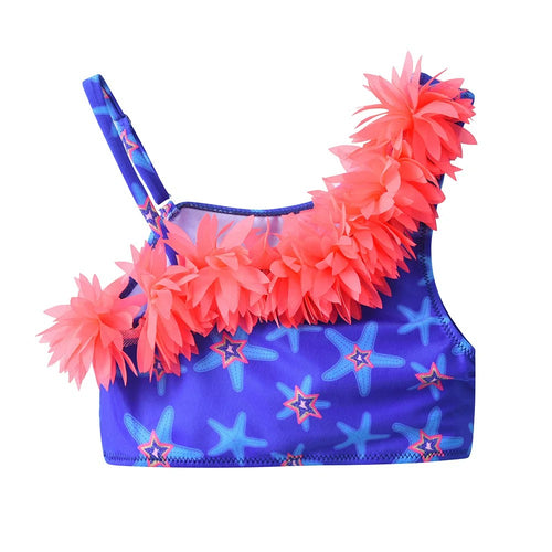 Children's swimsuit with pink floral details and starfish pattern on a blue background