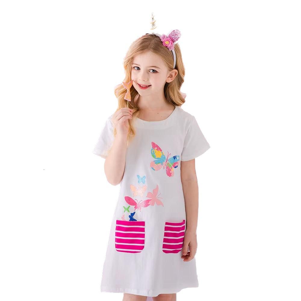 Young girl wearing a white dress with colorful butterfly designs on a white background