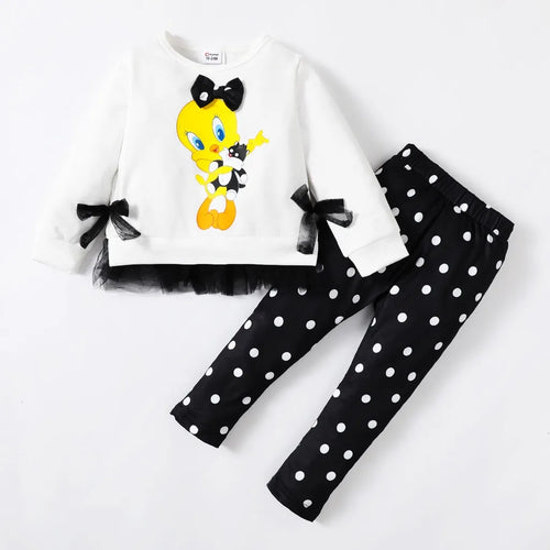 A toddler outfit with a white t-shirt featuring a cartoon character and black pants with a polka dot pattern.