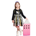 Young girl in a black dress with a unicorn design, holding a pink bag on a white background