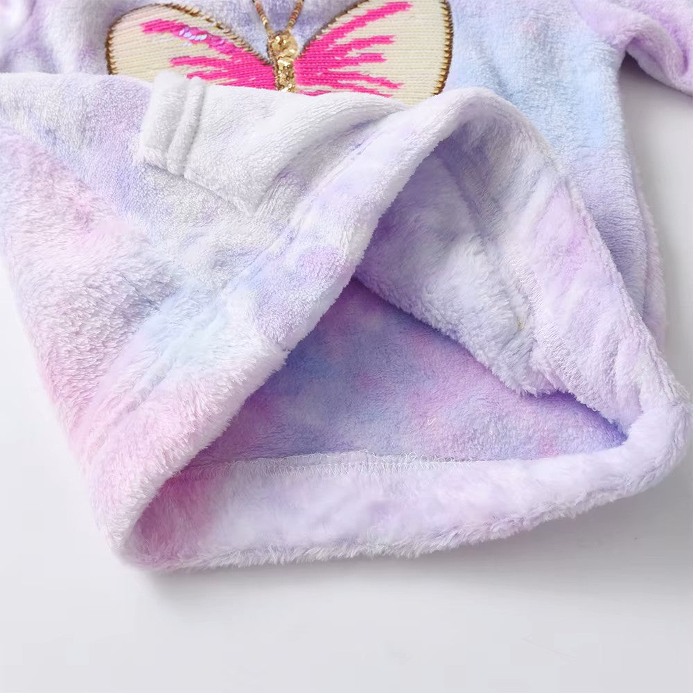 Folded purple and pink towel with butterfly design on a white background