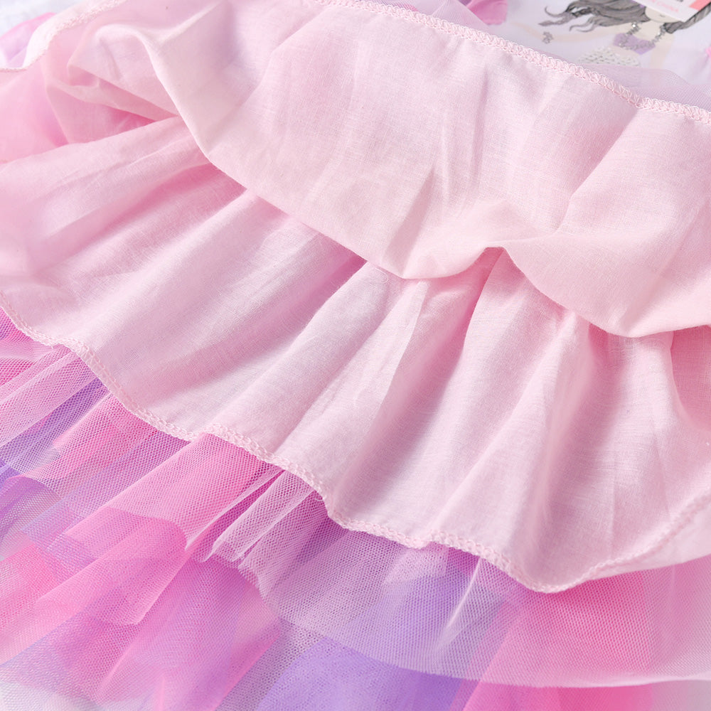 Close-up of a colorful tutu skirt with pink and purple layers.