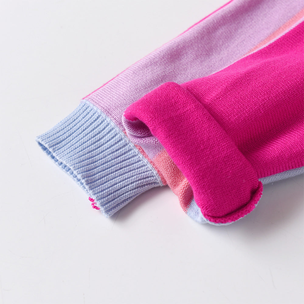 Folded pink and blue fabric on a light gray background