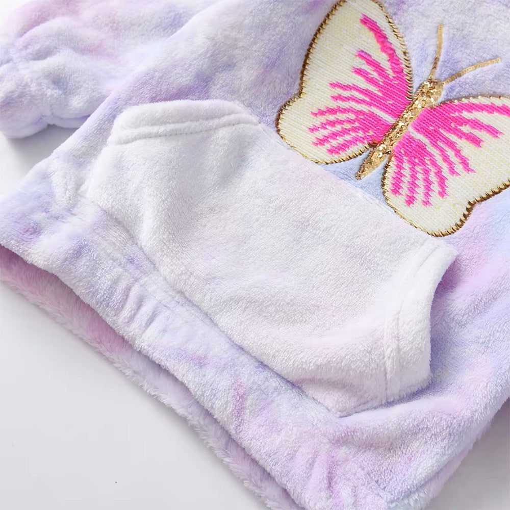 Fluffy blanket with a pink butterfly design on a light background