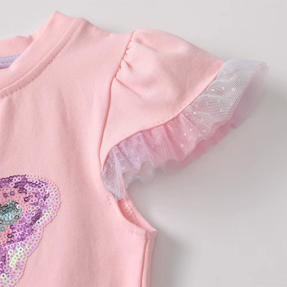 Pink shirt with sequin details on a light gray background