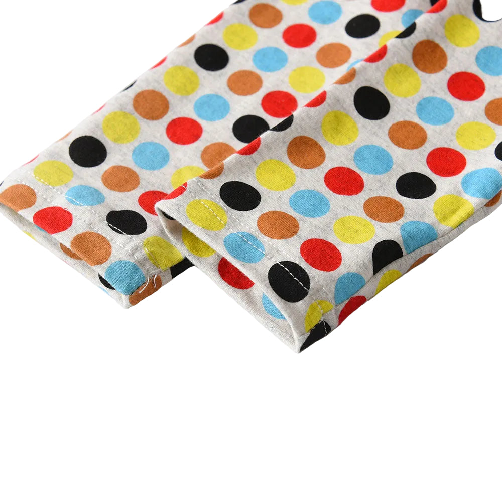 Two folded fabric swatches with colorful polka dot patterns on a white background