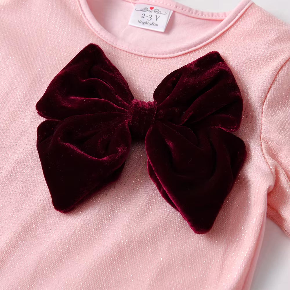 Pink shirt with a large burgundy velvet bow on a white background