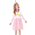 Girl size 7 wearing a white long-sleeve shirt with a sequin unicorn design Dress and a pink tutu skirt dress, standing against a white background.