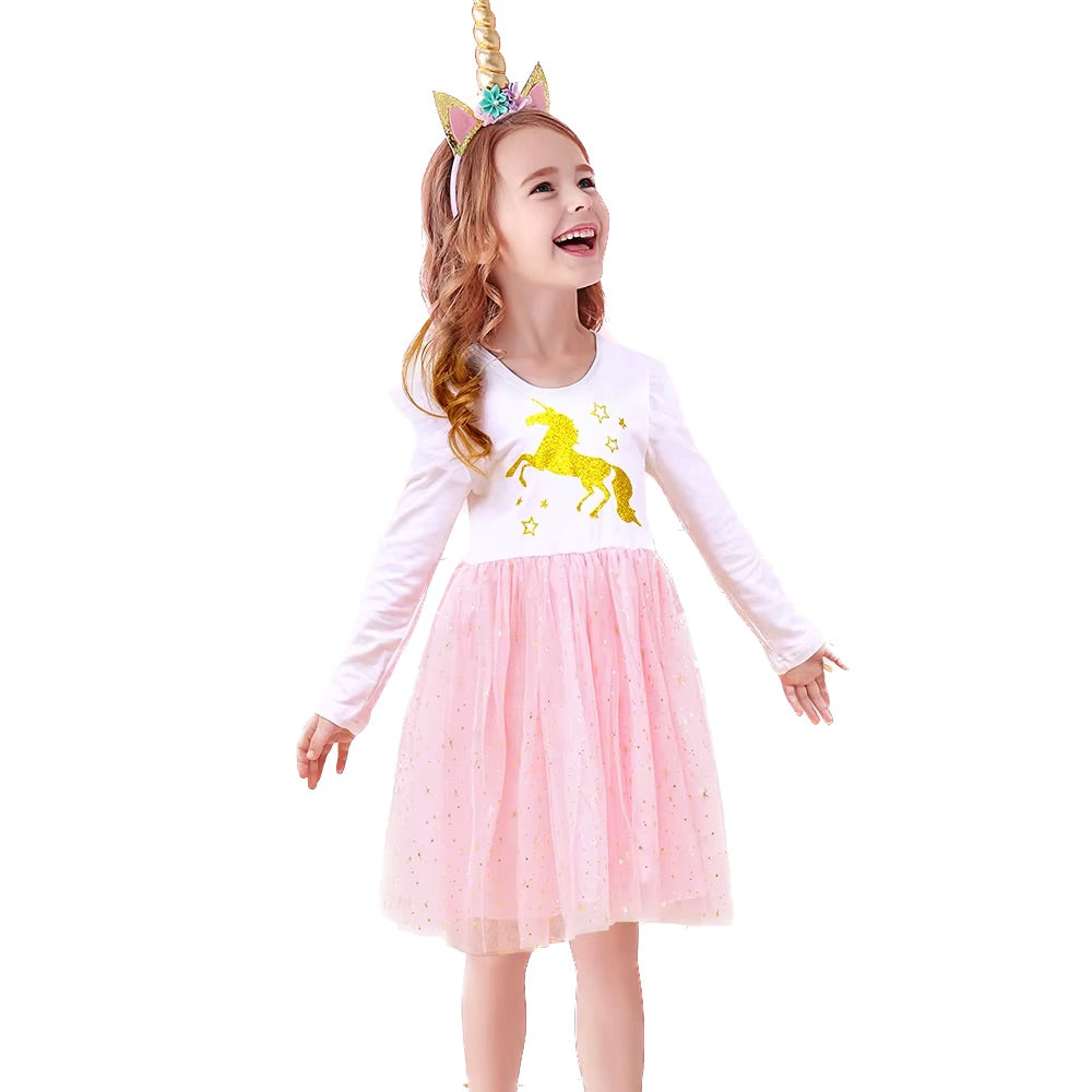 Girl size 7 wearing a white long-sleeve shirt with a sequin unicorn design Dress and a pink tutu skirt dress, standing against a white background.