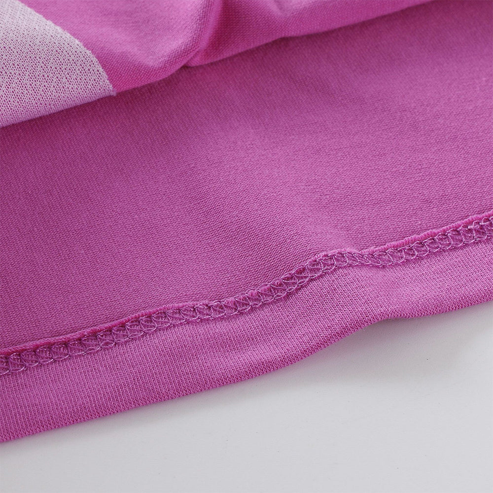 Close-up of pink fabric with a white border on a light gray background