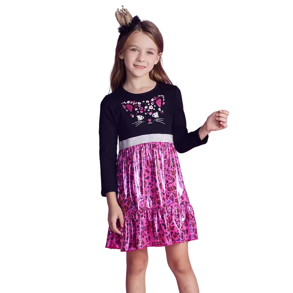 Young girl wearing a black top with pink cat design and a pink leopard print skirt on a white background
