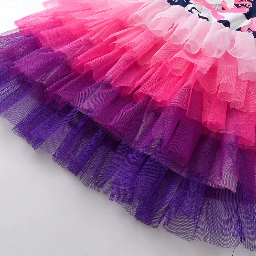 Close-up of a colorful tutu skirt with pink and purple layers on a white background