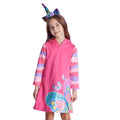 Child wearing a pink hooded dress with butterfly design and unicorn horn headband on a white background