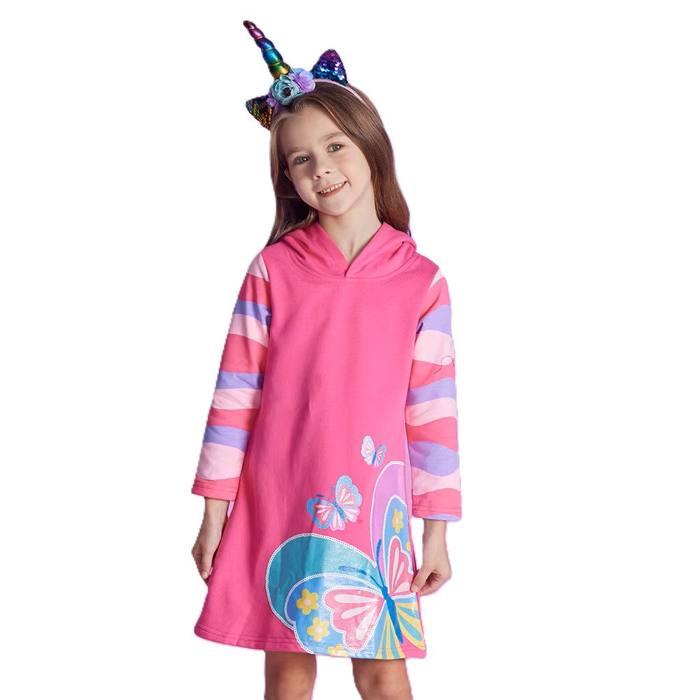 Child wearing a pink hooded dress with butterfly design and unicorn horn headband on a white background