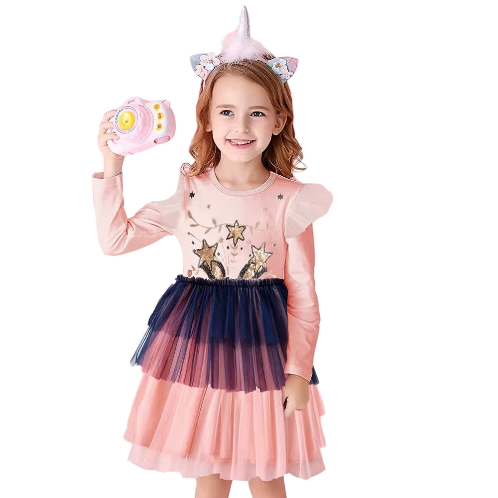 Young girl in a pink dress with star design, holding a pink toy, on a white background