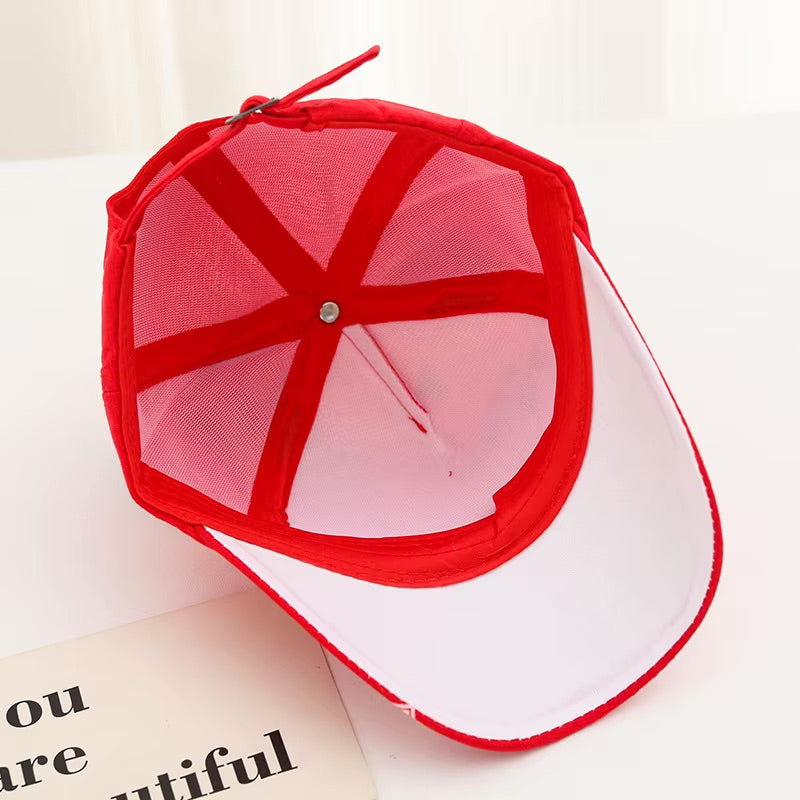 Red and white baseball cap with mesh design on a light background