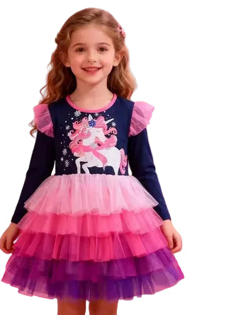 Young girl wearing a colorful dress with a unicorn design on a white background