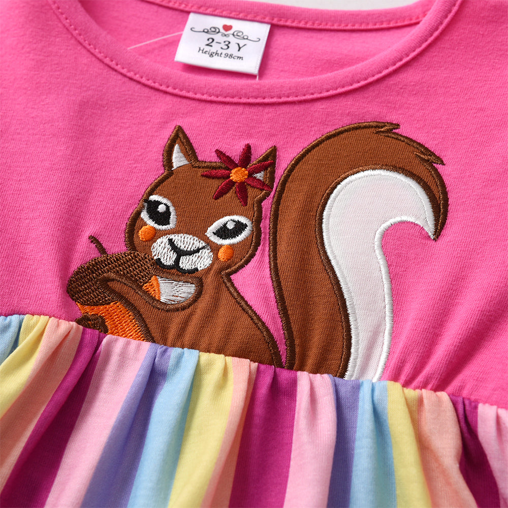 Pink dress with a cartoon squirrel design and colorful stripes, worn by a child.