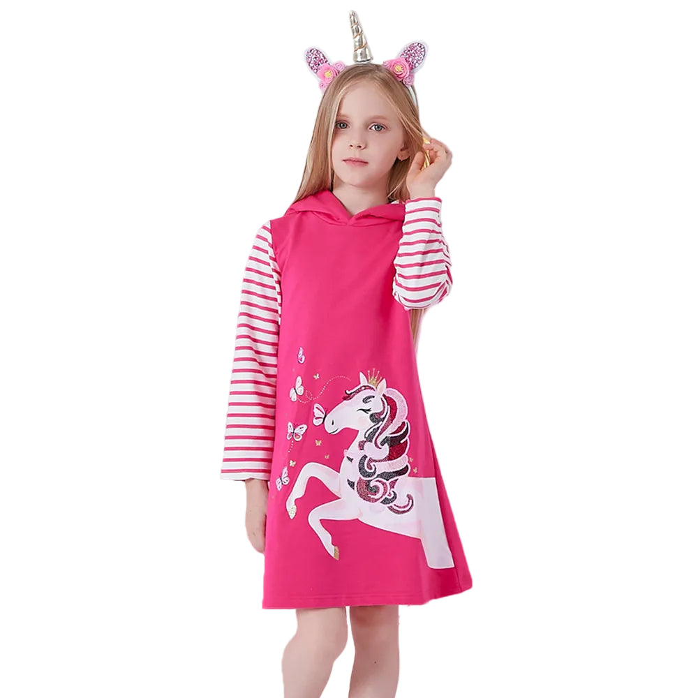 Child wearing a pink unicorn dress with a white background