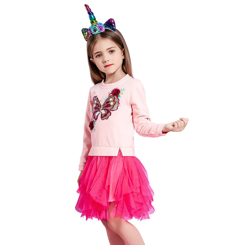 Young girl in a pink outfit with a butterfly design and colorful unicorn horn headband on a white background