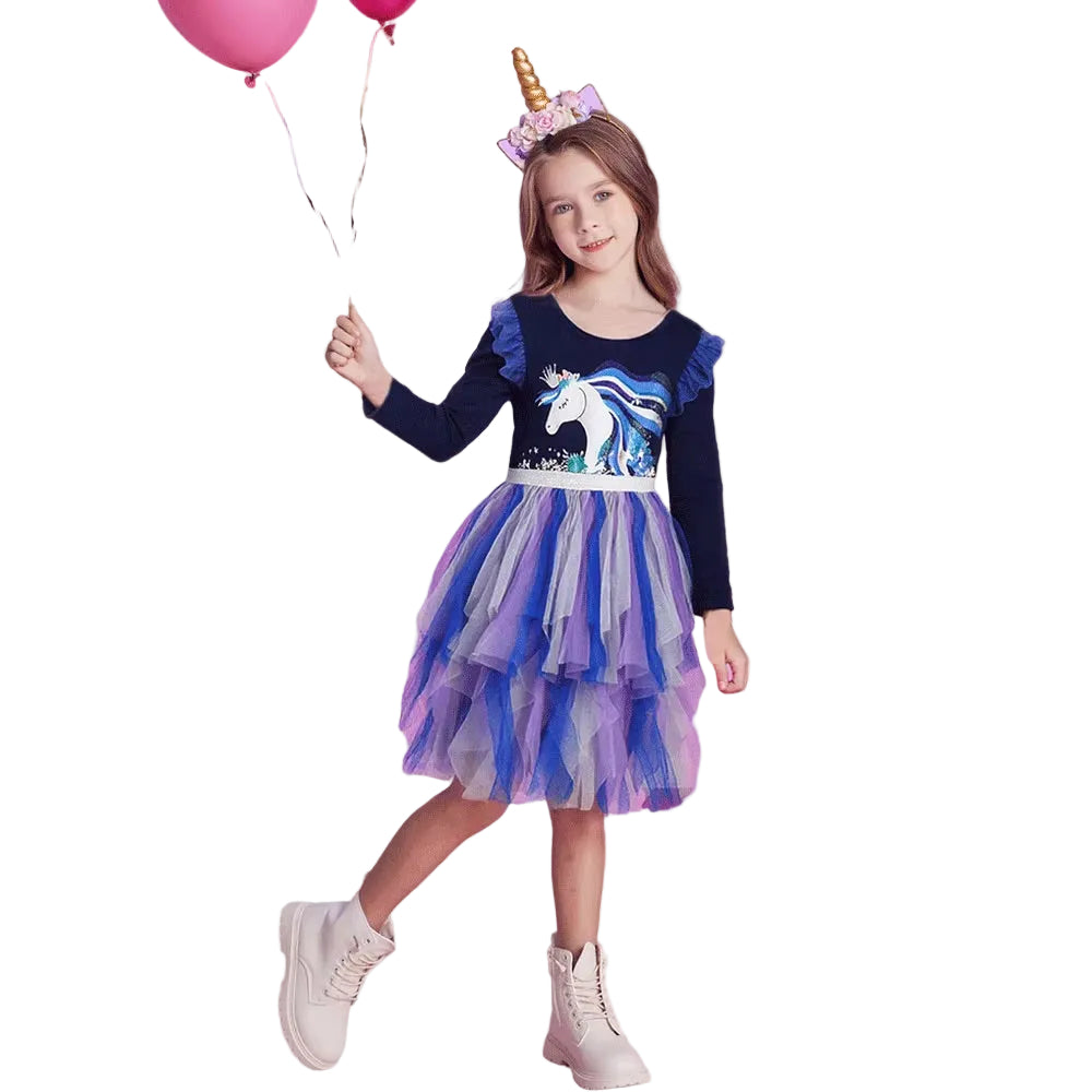 Girl in a unicorn-themed dress with balloons on a white background
