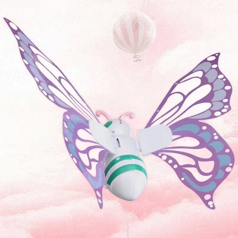 Butterfly-shaped toy with purple and white wings on a soft pink background