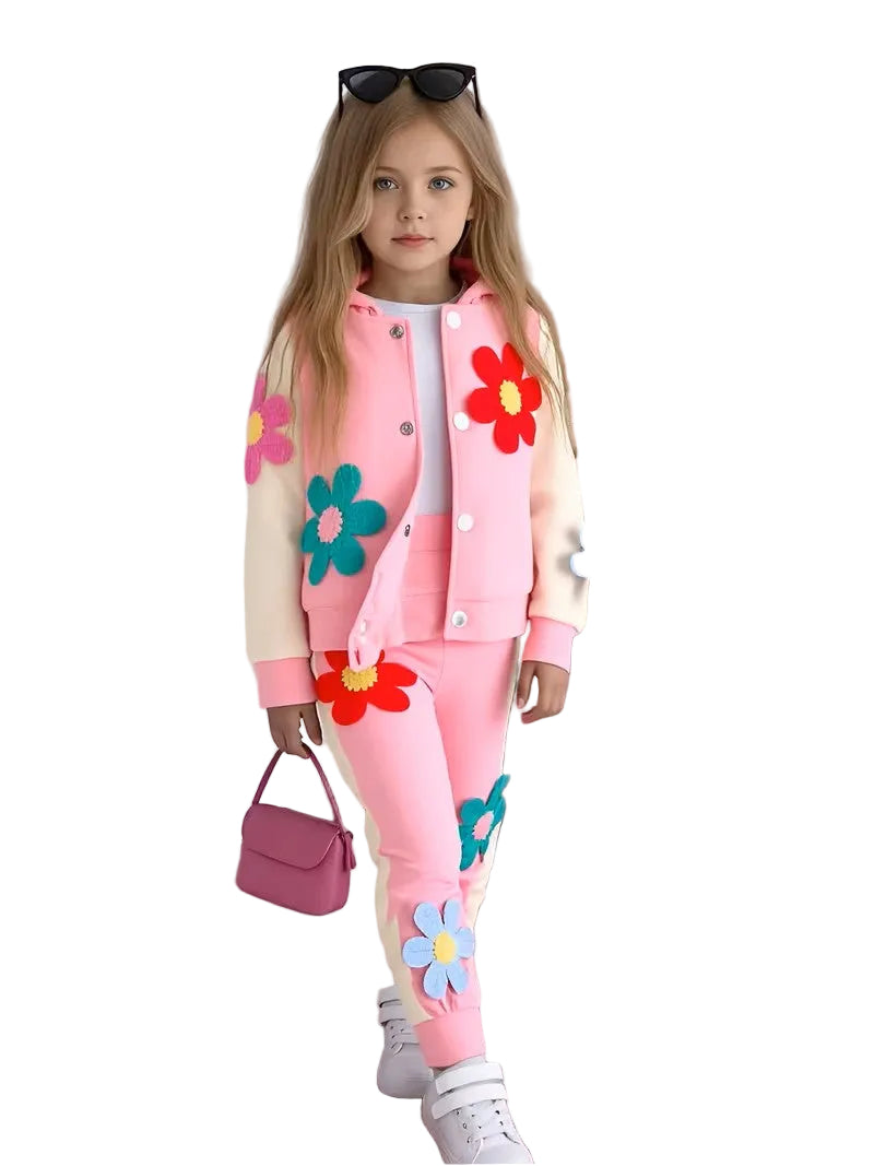 Child wearing a pink outfit with floral designs on a white background
