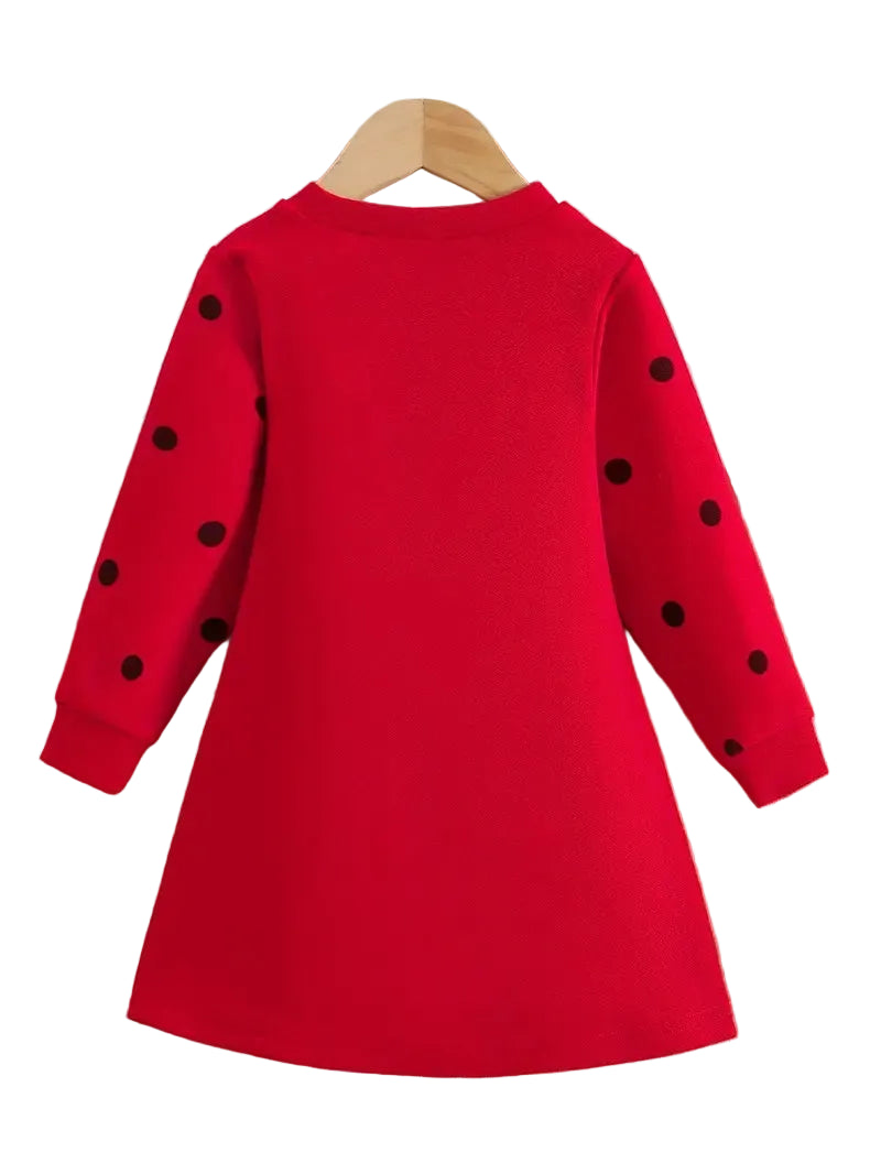 Red dress with black polka dots on a hanger against a white background