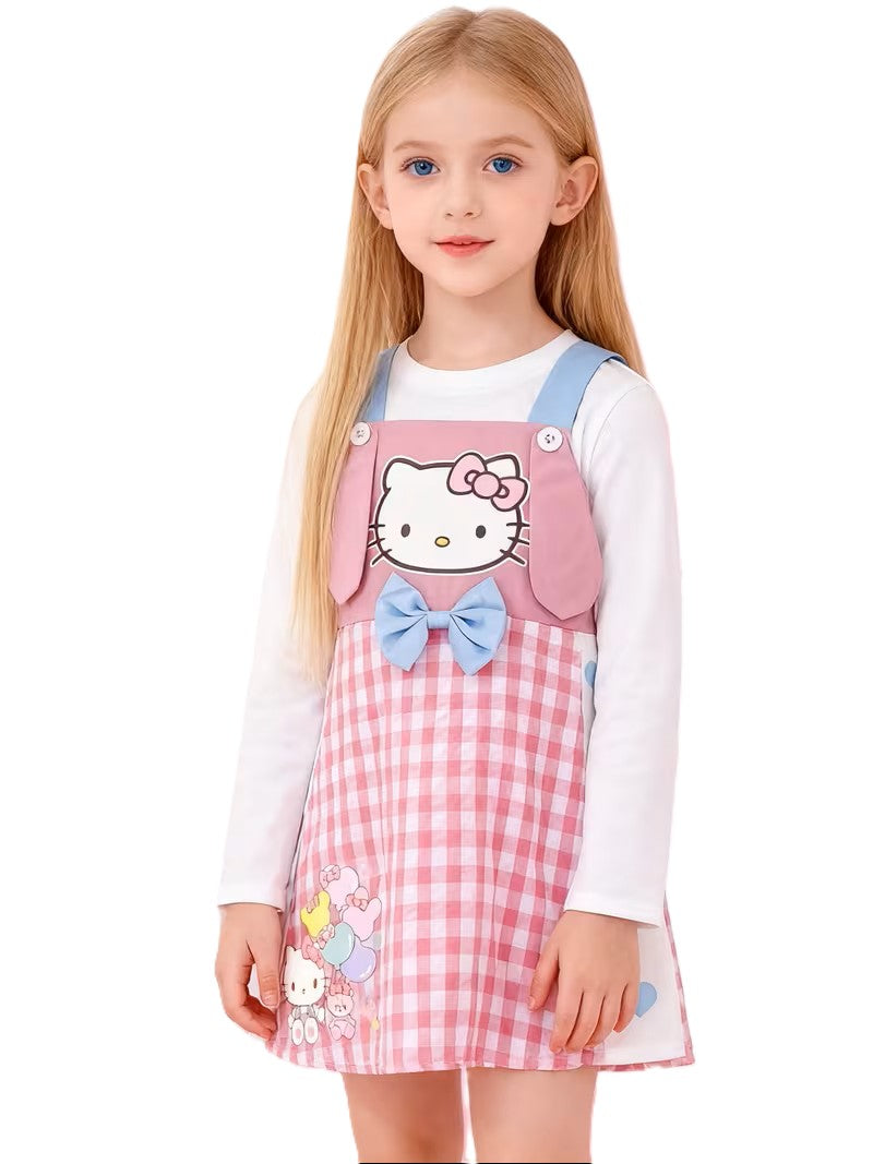 Young girl wearing a pink checkered dress with Hello Kitty design on a white background