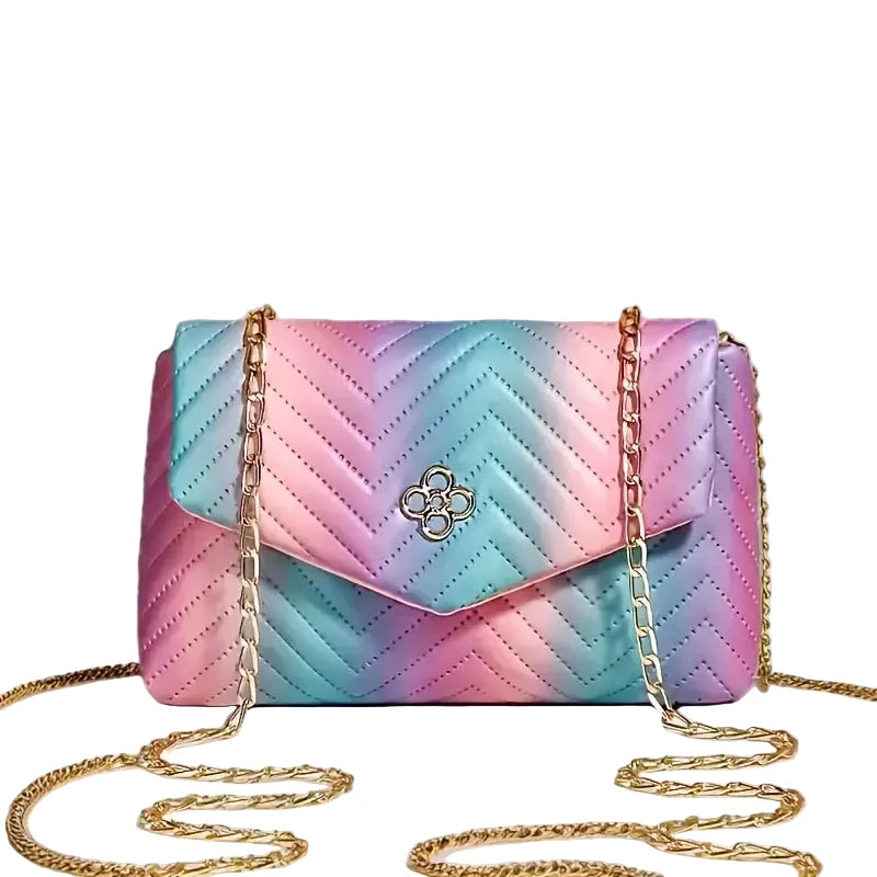Multicolored quilted handbag with gold chain on a light gray background